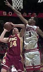 USC's Brian Scalabrine goes up for a shot over Arizona's Loren Woods during the Trojans' 71-58 loss Thursday night.