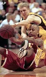 USC's Brandon Granville fights for a loose ball with ASU's during first half action of the Trojans' 77-58 victory Saturday afternoon.