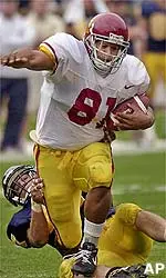 TE Alex Holmes is dragged down by Cal DE Josh Gustaveson in the first quarter.