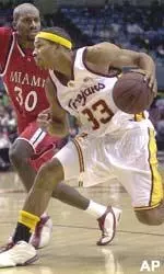 Desmon Farmer drives past Miami, Ohio's Doug Davis.