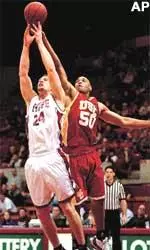 Washington State's J Locklier and Southern California's Sam Clancy fight for a rebound during the first half.