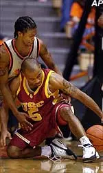 Brandon Granville fights for a loose ball with OSU's Jimmie Haywood during the first half of Thursday night's game.