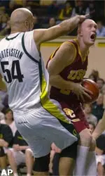 Brian Scalabrine drives to the basket against OU's Flo Hartenstein during USC's 87-80 overtime win.