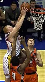 Brian Scalabrine puts up a shot over Oklahoma State defenders Andre Williams (40) and Jack Marlow (55) in the first round of the NCAA tournament in Uniondale, N.Y.