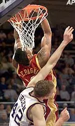 Jeff Trepagnier is fouled by Washington's Thalo Green while making a reverse dunk during the first half.
