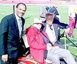 John McKay (center) on a recent visit to spring football practice pictured with Mike Garrett (left) and Rod Dedeaux (right).