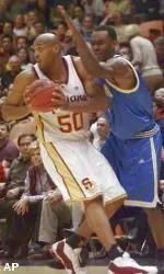 USC's Sam Clancy looks for an open teammate as UCLA's Billy Knight blocks him during the first half.
