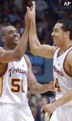 David Bluthenthal is congratulated by Sam Clancy after he made a 3-pointer from beyond half-court at the end of the first half.