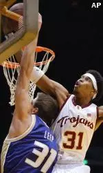 Jerry Dupree blocks a layup by Washington's Grant Leep in the first half.