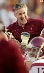 USC coach Pete Carroll celebrates with players after the Trojans' decisive 52-21 win.