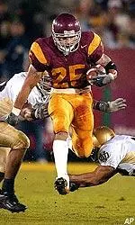 Justin Fargas jumps between Irish defenders during the first half.