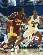 Ebony Hoffman drives for the basket guarded by UConn's Jessica Moore in the second half. Hoffman scored 22 points, but No. 3 Connecticut defeated USC 68-44. (AP Photo/Bob Child)