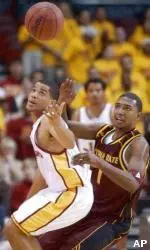 USC's Robert Hutchison temporarily loses control of the ball as he is defended by ASU's Jason Braxton.