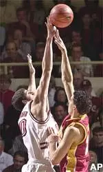 Center Rory O'Neil tries to get a shot over Stanford's Joe Kirchofer.