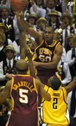 Sam Clancy passes to teammate Brandon Granville over California's A.J. Diggs during the first half.