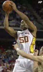 Sam Clancy shoots over a Seahawk defender in the first half. Clancy led the Trojans with 21 points.