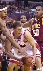 Desmon Farmer, left, and Sam Clancy bracket Arizona's Luke Walton on a rebound in the first half.