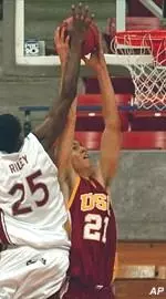 Rory O'Neil goes up for two of his 14 points during the Trojans' 97-90 win.