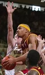 Desmon Farmer drives for two of his 23 points in the Trojans' 80-72 loss.