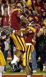 WR Steve Smith leaps into the arms of Hershel Dennis after Dennis scored a touchdown during the first half.