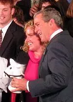 USC's Mikaela Parmlid presents President Bush with a Trojan gift.