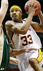 USC guard Desmon Farmer, right, drives to the basket against Cal Poly forward Nick Enzweiler during the first half.