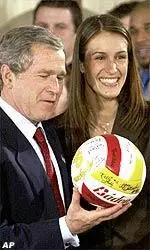 President Bush receives a volleyball signed by the entire USC women's volleyball team from Lauren Killian.