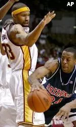 Desmon Farmer defends against Arizona's Andre Iguodala during the first half.