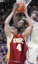 Gregg Guenther Jr., left, and Washington's Hakeem Rollins vie for the ball under the basket.
