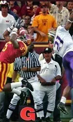 USC's Reggie Bush makes a catch for a touchdown as University of Washington's Derrick Johnson defends during the first half.