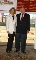 Helene and Lou Galen pose at the future center court of the Galen Center, which should be completed in the spring of 2006.
