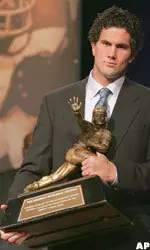 Matt Leinart picks up the Heisman trophy after being announced as the winner. (AP Photo/POOL, Julie Jacobson)