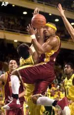 Desmon Farmer is fouled under the basket by Oregon's Ian Crosswhite during the first half at McArthur Court in Eugene, Ore.