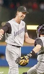 Arizona starter Randy Johnson celebrates with catcher Robby Hammock after pitching a perfect game against the Atlanta Braves Tuesday, May 18, 2004 in Atlanta. Arizona won 2-0.