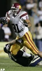 Alex Holmes gains four yards on the pass play before being taken down by BYU safety Jon Burbidge in the first quarter. (AP Photo/Douglas C. Pizac)