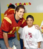 Matt Leinart and a young patient pose for a picture at the USC Children's Hospital.