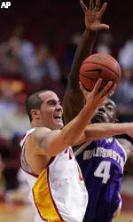 Gregg Guenther Jr. puts up a shot as Washington's Hakeem Rollins guards during the second half.