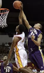 Alcorn State's Almaad Jackson (20) fouls USC's Nick Young as Alcorn State's Clifton Douglass (33) watches. (AP Photo/Ric Francis)