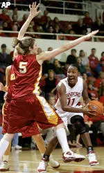 Stanford's Candice Wiggins, right, looks to pass as she is guarded by USC's Meghan Gnekow in the first half of their college basketball game in Stanford, Calif., Friday, Dec. 30, 2005. Stanford won 77-56. Wiggins led all scorers with 26 points. (AP Photo/Jeff Chiu)