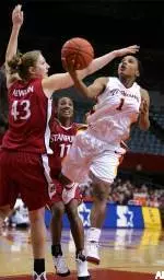 Camille Lenoir puts up a shot after leaping through the defense of Stanford's Kristen Newlin (43) and Candice Wiggins during the second half. (AP Photo/Danny Moloshok)