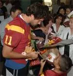 Quarterback Matt Leinart hands out gifts and signs autographs