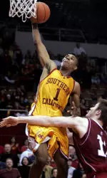 Southern California's Nick Young dunks over Washington State's Aron Baynes during the second half. Young had 32 points in USC's 71-66 win. (AP Photo/Matt Sayles)