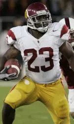 Chauncey Washington runs for good yardage in the second quarter. (AP Photo)