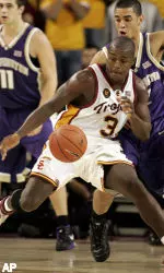 Lodrick Stewart controls the ball under pressure from Washington's Adrian Oliver in the Trojans' conference opening win. (AP Photo/Danny Moloshok)