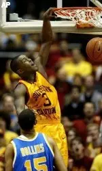 Southern California's Lodrick Stewart dunks the ball as UCLA's Ryan Hollins looks on during the first half. (AP Photo/Danny Moloshok)