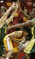 Nick Young is double-teamed by Oregon's Maarty Leunen, left, and Ivan Johnson during the first half. (AP Photo/Francis Specker)
