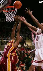 Stanford guard Tim Morris, right, and Nick Young go for rebound during the first half. (AP Photo/Paul Sakuma)
