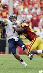 Kyle Moore hits Arizona's Willie Tuitama as he throws the ball in the Trojans' 20-13 win. (AP Photo/Mark J. Terrill)