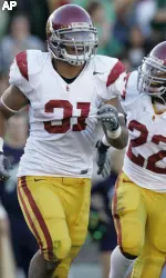 Southern California running back Stanley Havili, left, celebrates with teammate running back Desmond Reed after scoring a touchdown against Notre Dame during the third quarter. (AP Photo/Michael Conroy)