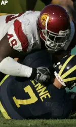 USC's Sedrick Ellis (49) sacks Michigan's Chad Henne (7) in the second quarter at the 93rd Rose Bowl football game. (AP Photo/Kevork Djansezian)